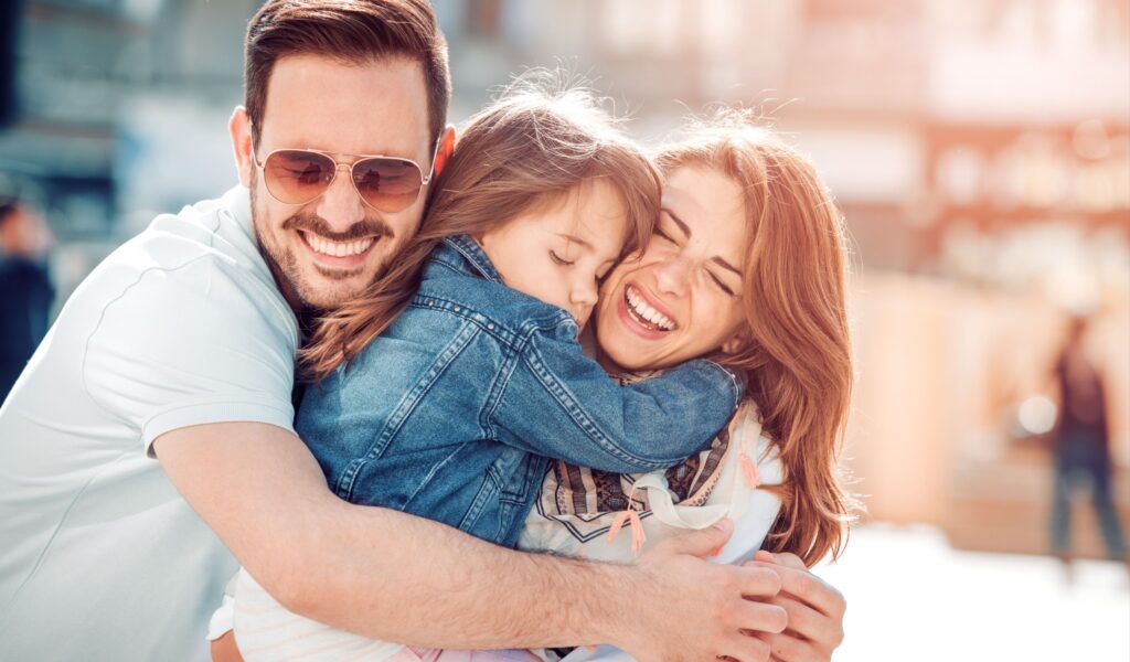 Smiling family selfie, representing healthy smiles and positive dental experience