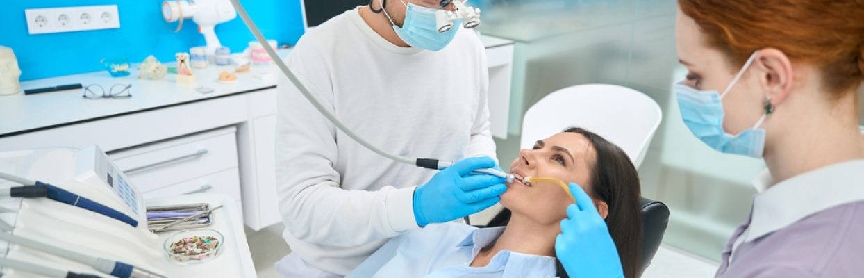 Dentist performing dental exam and preventive dentistry on patient in Hobbs, NM dental office